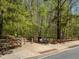 Picturesque walking trail entrance with a bench and informational signage, inviting nature enthusiasts at 309 Vista Ln, Woodstock, GA 30189