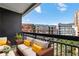 Cozy balcony seating area with a view of colorful buildings and a bright blue sky at 3481 Lakeside Ne Dr # 907, Atlanta, GA 30326