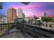 Balcony view with wrought iron railing overlooking city skyline at sunset at 3481 Lakeside Ne Dr # 907, Atlanta, GA 30326