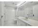 Bright white bathroom with a shower-tub combo, vanity, and a large framed mirror at 3481 Lakeside Ne Dr # 907, Atlanta, GA 30326