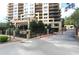 Building entrance and gate with manicured landscaping and mature trees at 3481 Lakeside Ne Dr # 907, Atlanta, GA 30326