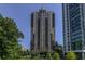 View of high-rise apartment buildings, green trees, and blue skies at 3481 Lakeside Ne Dr # 907, Atlanta, GA 30326