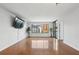 Bright living room with wall mounted TV, hardwood floors, and floor-to-ceiling windows at 3481 Lakeside Ne Dr # 907, Atlanta, GA 30326