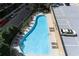 Aerial view of the community pool with lounge chairs, parking and lush greenery at 3481 Lakeside Ne Dr # 907, Atlanta, GA 30326