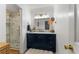 Modern bathroom featuring a marble vanity, stylish lighting, and a glass shower at 408 Brighton Pt, Atlanta, GA 30328