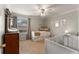 Bright Bedroom featuring a crib, daybed and dresser, illuminated by a ceiling fan and natural light at 408 Brighton Pt, Atlanta, GA 30328
