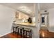 Eat-in kitchen features granite countertops, bar stool seating, and modern track lighting at 408 Brighton Pt, Atlanta, GA 30328