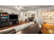 Open concept living room with hardwood floors, media center, and view into dining and kitchen at 408 Brighton Pt, Atlanta, GA 30328