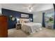 Cozy main bedroom with blue accent wall, ceiling fan, and lots of natural light from window at 408 Brighton Pt, Atlanta, GA 30328