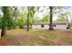 Large, grassy backyard with mature trees and wooden fence, offering privacy and space for recreation and relaxation at 4506 Dorset Dr, Decatur, GA 30035