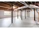 Unfinished basement with exposed ceiling, support beams, and painted concrete walls and floors, offering customization potential at 4506 Dorset Dr, Decatur, GA 30035