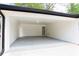 Spacious attached carport with white brick walls and a door to the backyard at 4506 Dorset Dr, Decatur, GA 30035