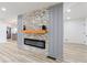 Modern fireplace with stone surround and a wooden mantle between arched entryways at 4506 Dorset Dr, Decatur, GA 30035