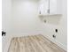 Small laundry room with white cabinets for storage and hookups at 4506 Dorset Dr, Decatur, GA 30035