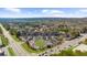 An aerial view of a neighborhood featuring a mix of residential and commercial buildings and ample parking at 6088 Holly Park Se Ln, Mableton, GA 30126