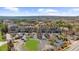 An aerial view showcases neighborhood buildings with parking and surrounding trees at 6088 Holly Park Se Ln, Mableton, GA 30126