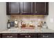 Sophisticated bar area features granite countertops, dark cabinets, and wine storage for entertaining at 6088 Holly Park Se Ln, Mableton, GA 30126