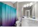 Bathroom featuring a toilet, a vanity, and a shower with a purple and blue curtain at 6088 Holly Park Se Ln, Mableton, GA 30126