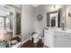 Well-lit bathroom featuring a white vanity, framed mirror, and a tiled walk-in shower at 6088 Holly Park Se Ln, Mableton, GA 30126