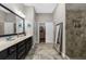 Modern bathroom with a double sink vanity, a large mirror, and a beautifully tiled walk-in shower at 6088 Holly Park Se Ln, Mableton, GA 30126