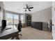 Bright bedroom with large windows, a ceiling fan, and neutral paint; furnished with a desk at 6088 Holly Park Se Ln, Mableton, GA 30126