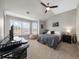 Comfortable bedroom with a desk, a ceiling fan, and natural light from the large window at 6088 Holly Park Se Ln, Mableton, GA 30126