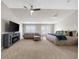 Spacious bedroom featuring a ceiling fan, TV, fireplace, a large bed, and a comfortable couch at 6088 Holly Park Se Ln, Mableton, GA 30126