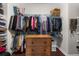 Organized walk-in closet with ample hanging space, shelving, and a dresser for maximum storage at 6088 Holly Park Se Ln, Mableton, GA 30126