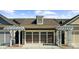 Home garage with pergola detail, brown doors, and the house number displayed on the exterior at 6088 Holly Park Se Ln, Mableton, GA 30126