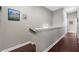 Upstairs hallway with hardwood floors and neutral paint at 6088 Holly Park Se Ln, Mableton, GA 30126