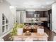 Open-concept kitchen boasts stainless steel appliances, dark cabinetry, and a breakfast bar island at 6088 Holly Park Se Ln, Mableton, GA 30126