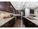 Well-lit kitchen featuring stainless steel appliances, dark wood cabinetry, and a large island at 6088 Holly Park Se Ln, Mableton, GA 30126