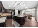 Open concept kitchen with an island, stainless appliances, dark cabinets and access to the living room at 6088 Holly Park Se Ln, Mableton, GA 30126