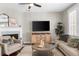Comfortable living room with a fireplace, TV, and plenty of natural light at 6088 Holly Park Se Ln, Mableton, GA 30126