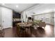 Open living space with kitchen and living room, featuring dark wood floors and a bar area at 6088 Holly Park Se Ln, Mableton, GA 30126