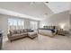 Sun-filled main bedroom with a sitting area, large windows, and a ceiling fan at 6088 Holly Park Se Ln, Mableton, GA 30126