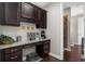 Home office featuring dark cabinetry, granite countertops, and a built in desk in an alcove at 6088 Holly Park Se Ln, Mableton, GA 30126