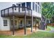 View of the two-story home featuring an outdoor deck with backyard and stairs at 1900 Denton Walk Ct, Marietta, GA 30062