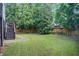 Exterior view of backyard featuring trees and wooden fence at 1900 Denton Walk Ct, Marietta, GA 30062