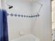 Clean bathroom featuring a bathtub with a shower and blue diamond accents at 1900 Denton Walk Ct, Marietta, GA 30062