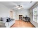 Bright bedroom with hardwood floors and a large window, furnished with a grey sofa, and desk at 1900 Denton Walk Ct, Marietta, GA 30062