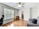 Bedroom includes a ceiling fan, a large window, hardwood floors, and an adjacent bathroom at 1900 Denton Walk Ct, Marietta, GA 30062