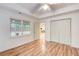 Bedroom featuring hardwood floors, ceiling fan and closet doors to optimize space at 1900 Denton Walk Ct, Marietta, GA 30062