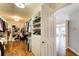 Walk-in closet with custom shelving and hardwood floors, leading to an adjoining room at 1900 Denton Walk Ct, Marietta, GA 30062