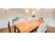 Bright dining area with a rustic table, upholstered chairs, and elegant wall sconces at 1900 Denton Walk Ct, Marietta, GA 30062