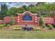 Community entrance sign with colorful flowerbeds and well-maintained landscaping at 1900 Denton Walk Ct, Marietta, GA 30062