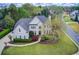 Exterior elevation of home with beautifully landscaped lawn, garden beds and concrete driveway at 1900 Denton Walk Ct, Marietta, GA 30062