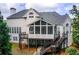 Rear exterior view of home featuring a screened porch and backyard at 1900 Denton Walk Ct, Marietta, GA 30062