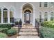 Elegant home entrance featuring a stone pathway, iron railings, and manicured greenery at 1900 Denton Walk Ct, Marietta, GA 30062