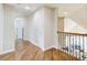 Bright hallway features hardwood floors, neutral paint, and access to other rooms within the home at 1900 Denton Walk Ct, Marietta, GA 30062
